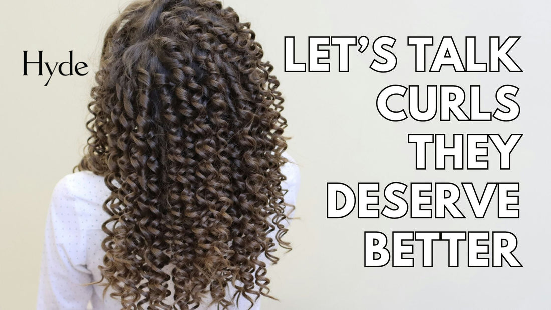 Curly-haired guest smiling after a fresh cut at Hyde Salon.