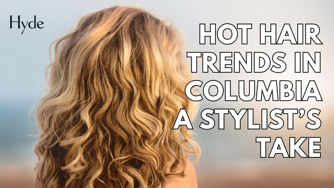 Stylist adding soft layers to a client’s brunette hair in a modern Columbia salon.