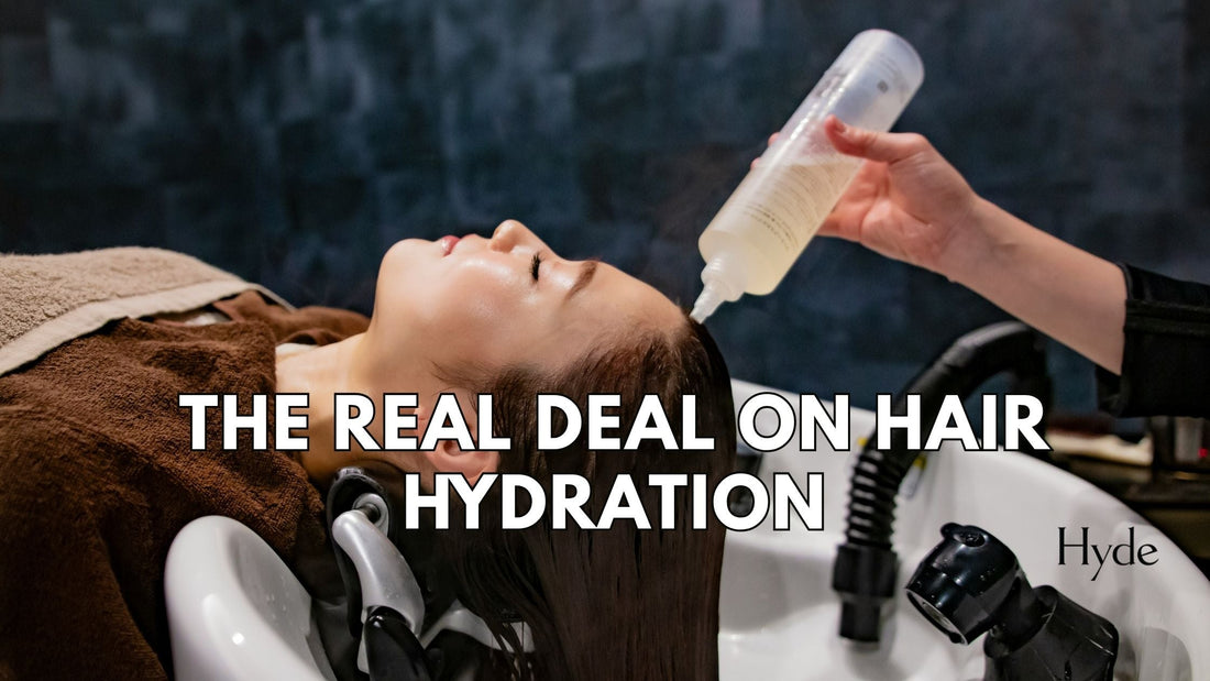 Stylist Megan Carter at Hyde Salon holding top hydration products for healthy, shiny hair.