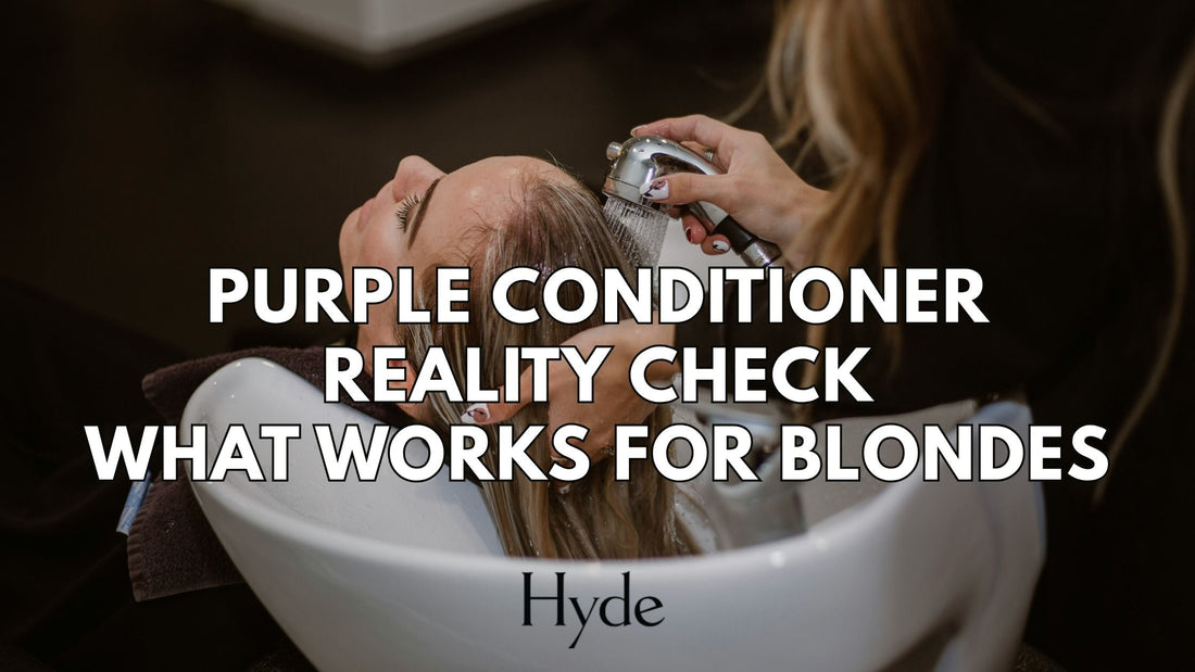 Blonde client with fresh highlights styled by a Hyde Salon stylist, holding purple conditioner.
